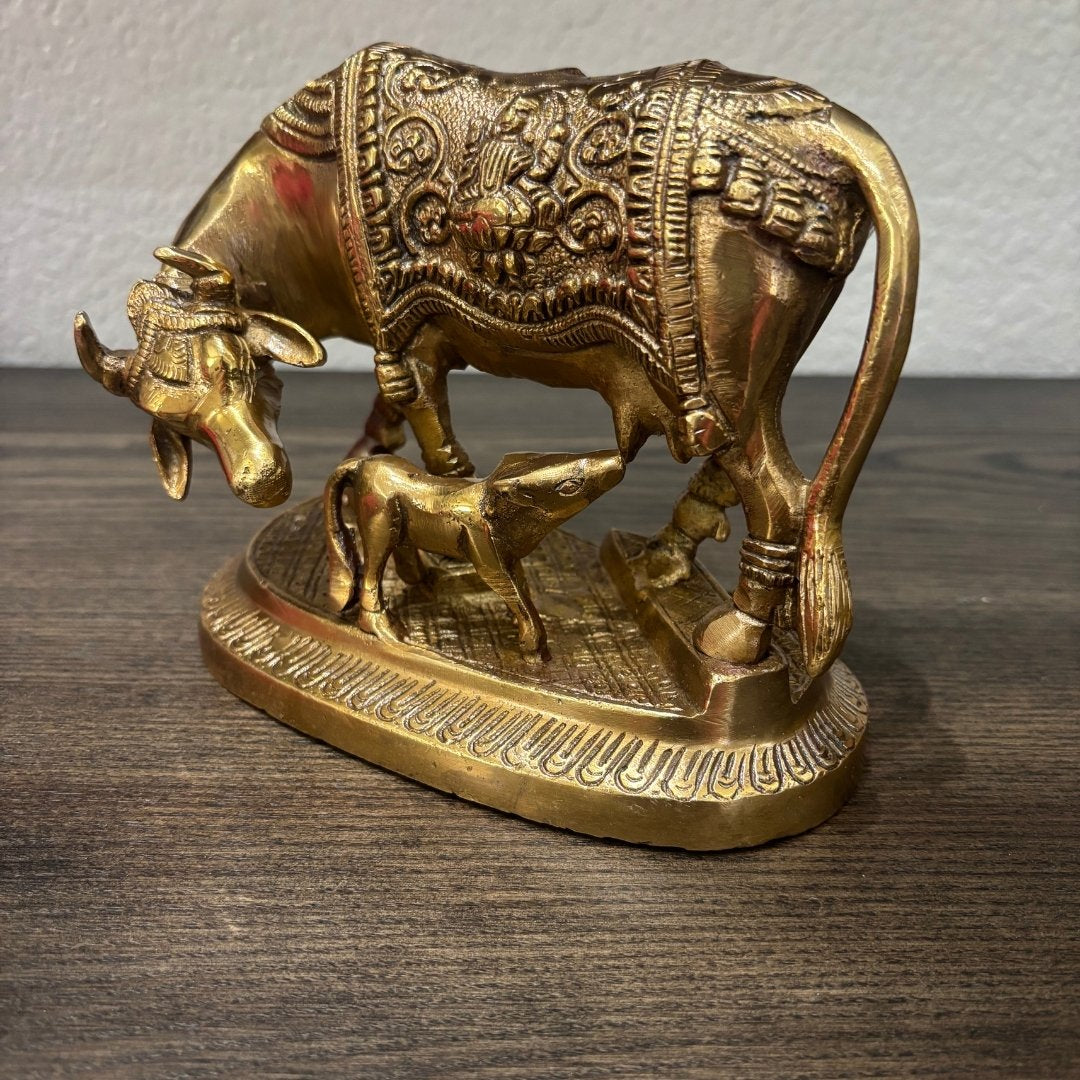 Close-up of engraved Brass Kamdhenu Cow and Calf statue, fine handcrafted detailing