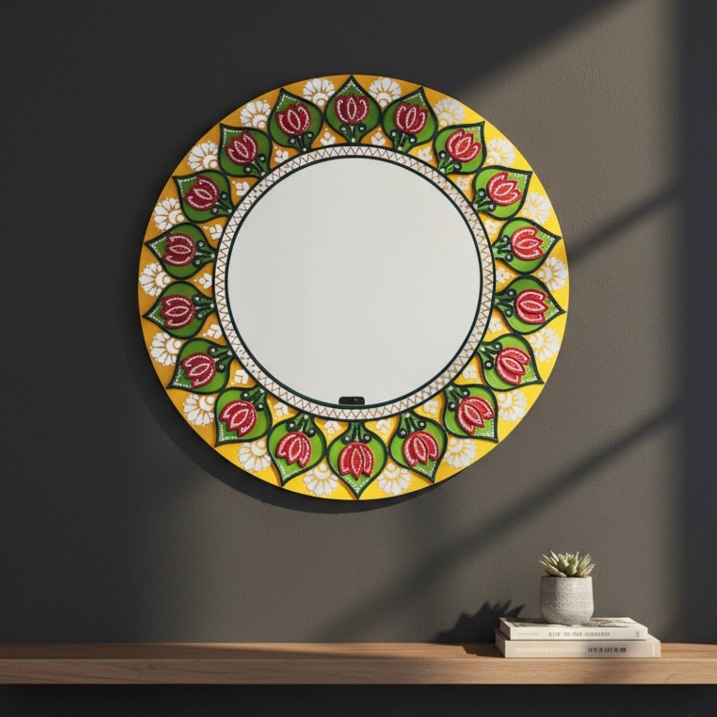 Decorative round mirror with floral pattern on a dark wall