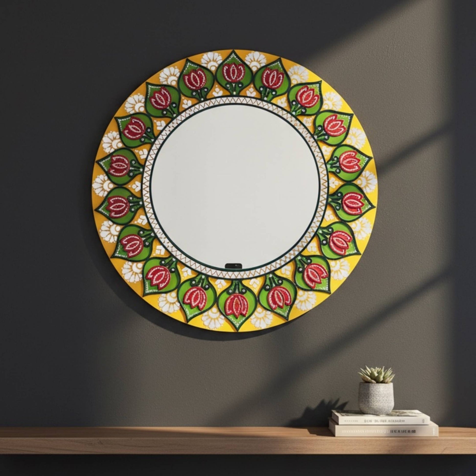 Decorative round mirror with floral pattern on a dark wall