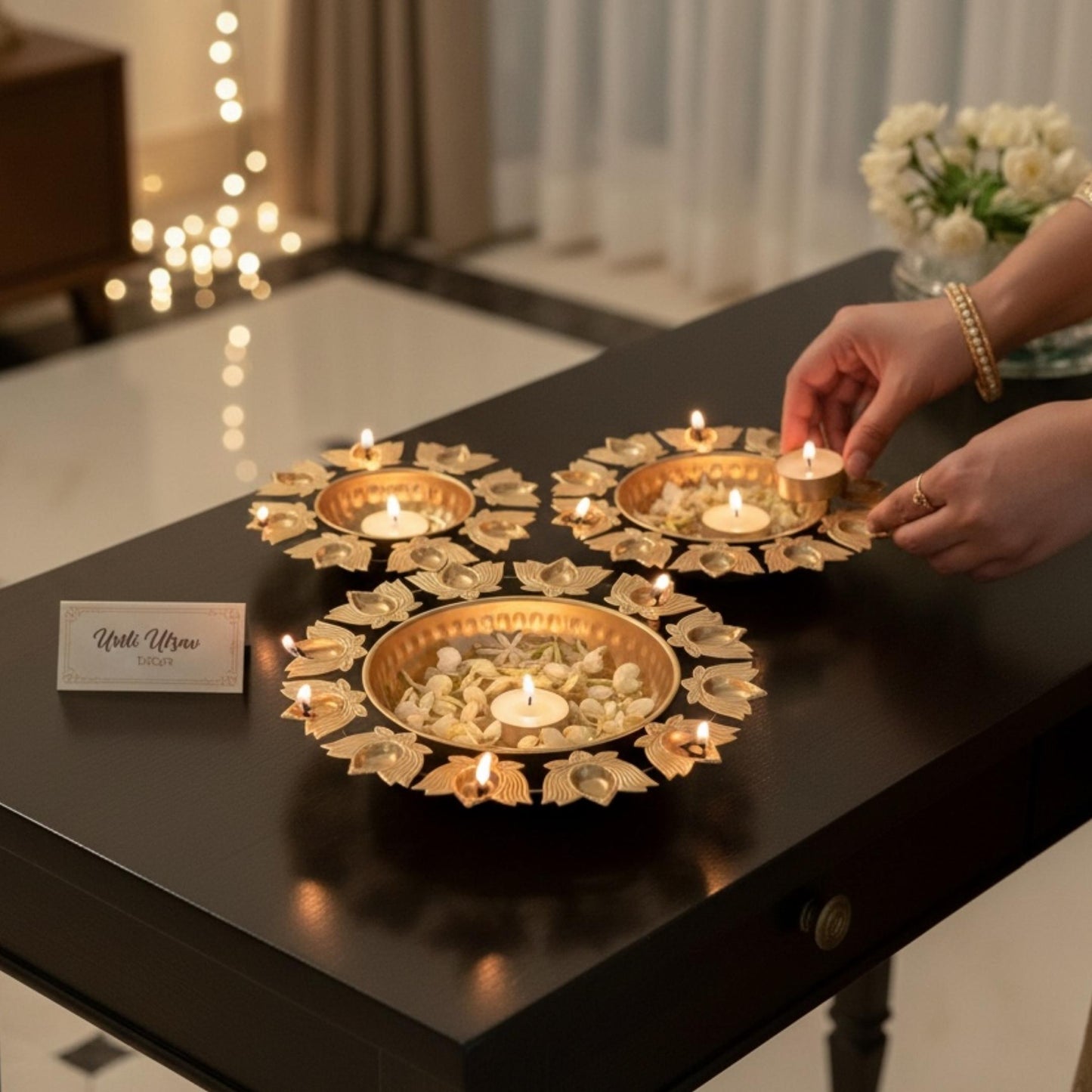 Decorative gold urli bowl filled with water, floating flowers, and candles for Diwali decorations.