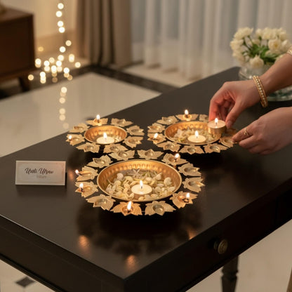 Decorative gold urli bowl filled with water, floating flowers, and candles for Diwali decorations.