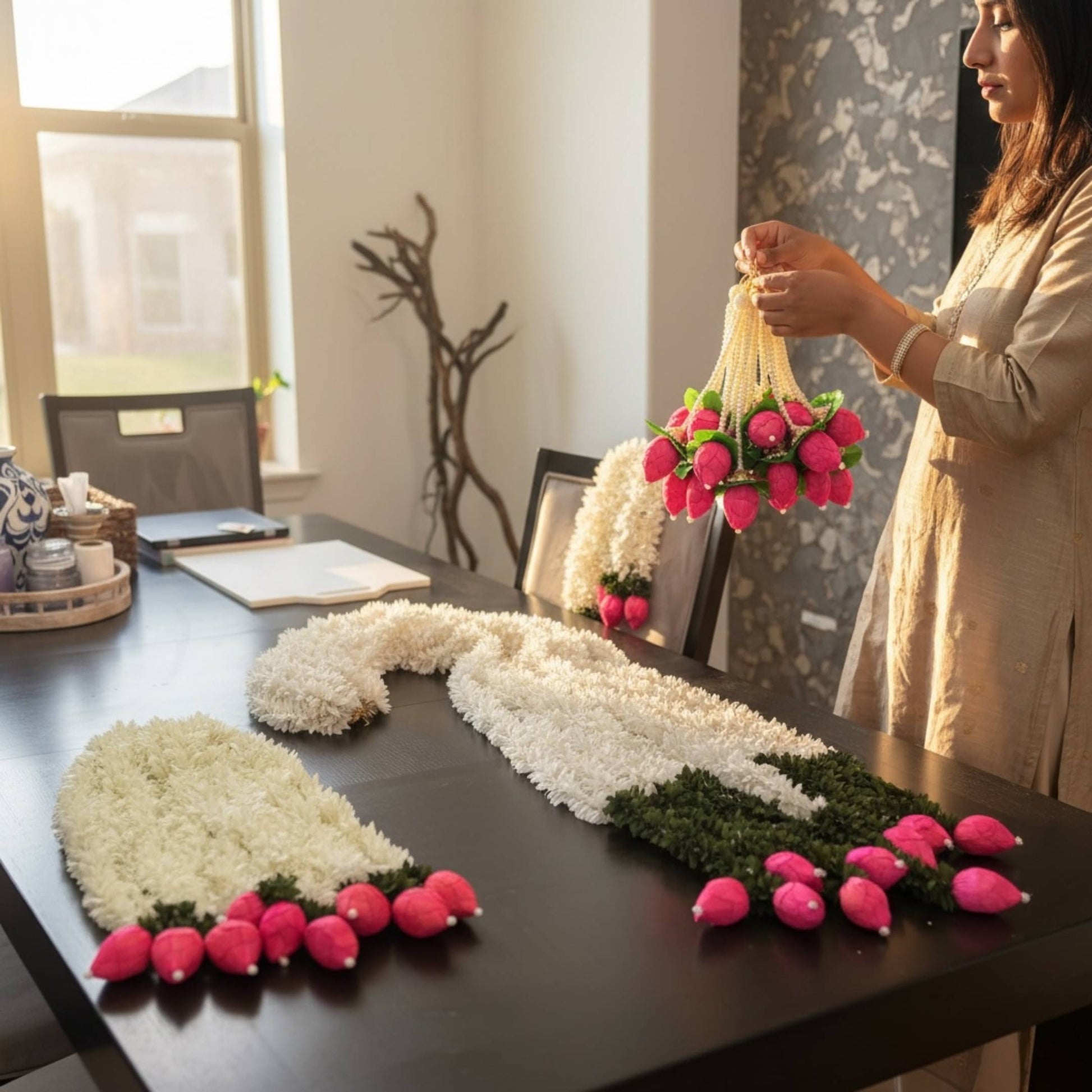 Woman decorating a table with handcrafted jasmine lotus bud fabric garlands – set of 10 artificial Indian floral garlands for home decor