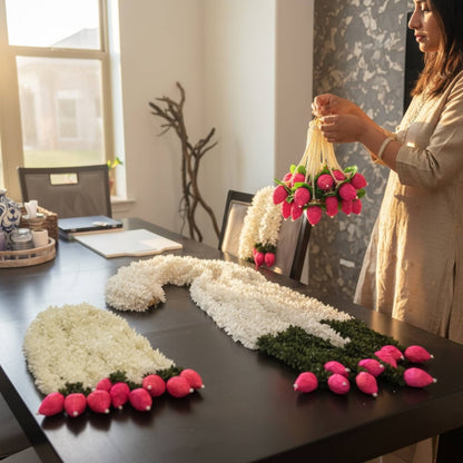 Woman decorating a table with handcrafted jasmine lotus bud fabric garlands – set of 10 artificial Indian floral garlands for home decor