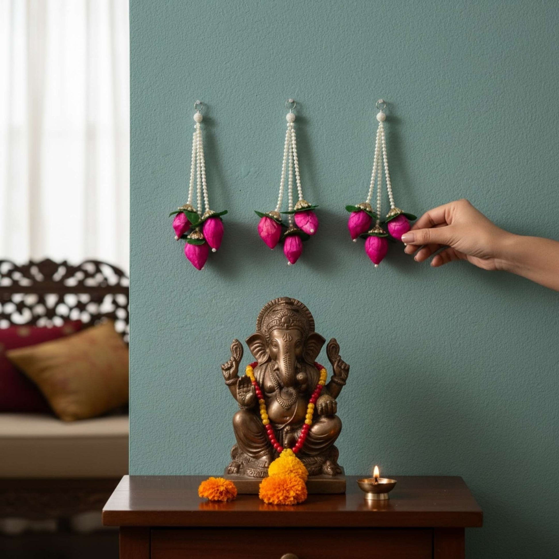 Pink jasmine lotus bud fabric garland displayed beside a Ganesha idol – handmade Indian artificial garland for Ganesh Chaturthi and pooja decor