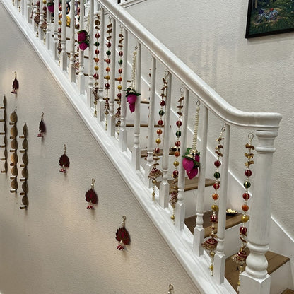 Set of handmade jasmine lotus bud fabric garlands hung on a staircase railing