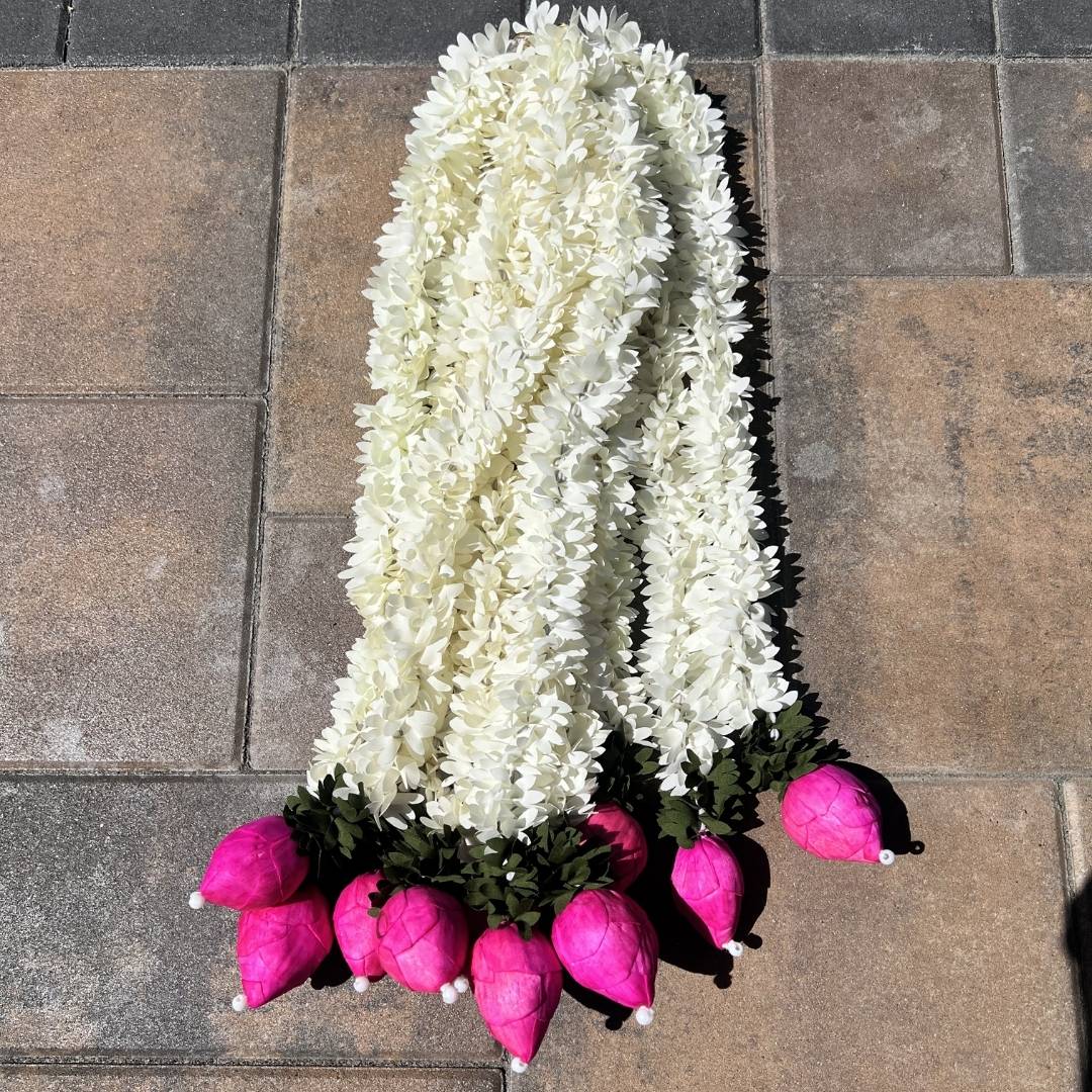 2-foot white jasmine and pink lotus bud fabric garland on stone surface – handmade artificial Indian garland with sola wood buds and faux pearls