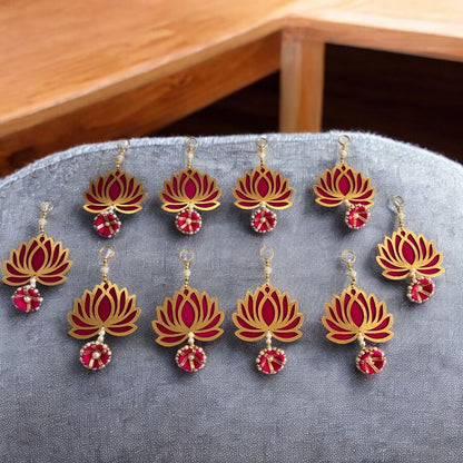 Red and gold lotus-shaped garland on a gray surface with a wooden background