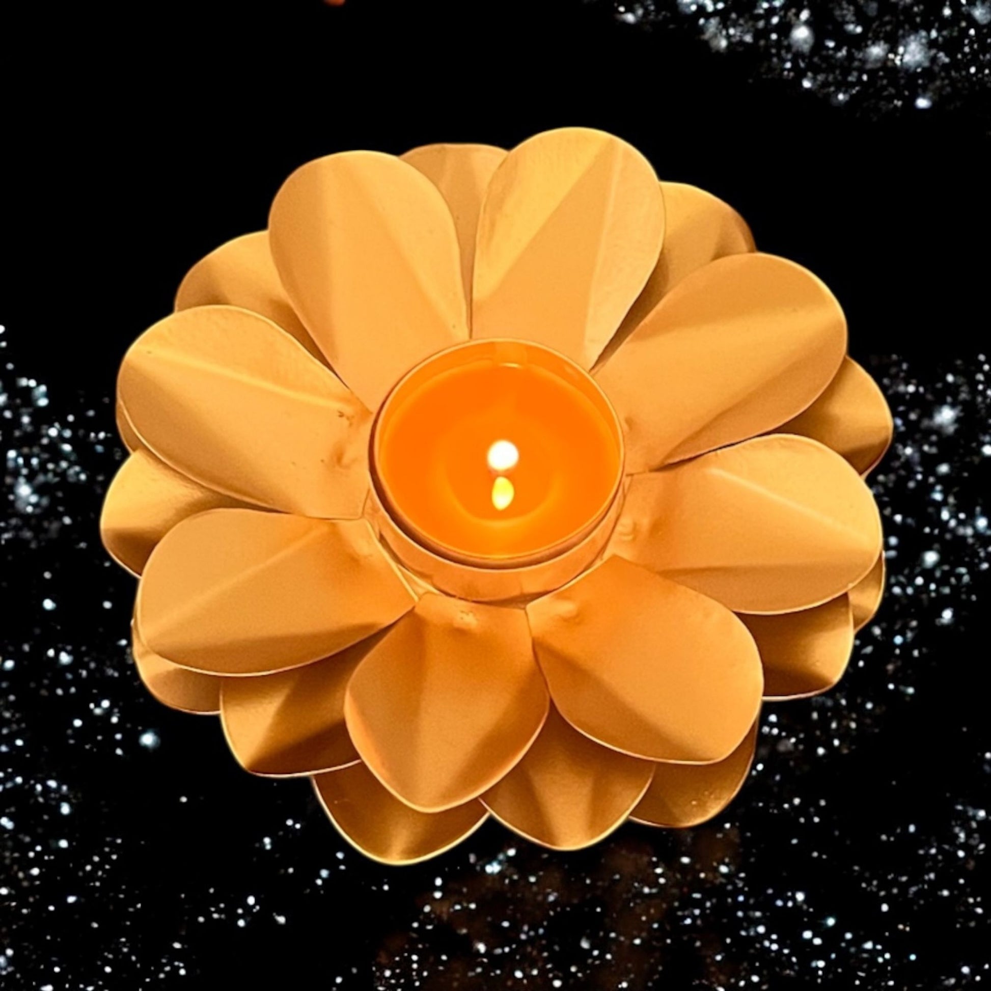 Flower-shaped candle holder with a lit candle on a black background