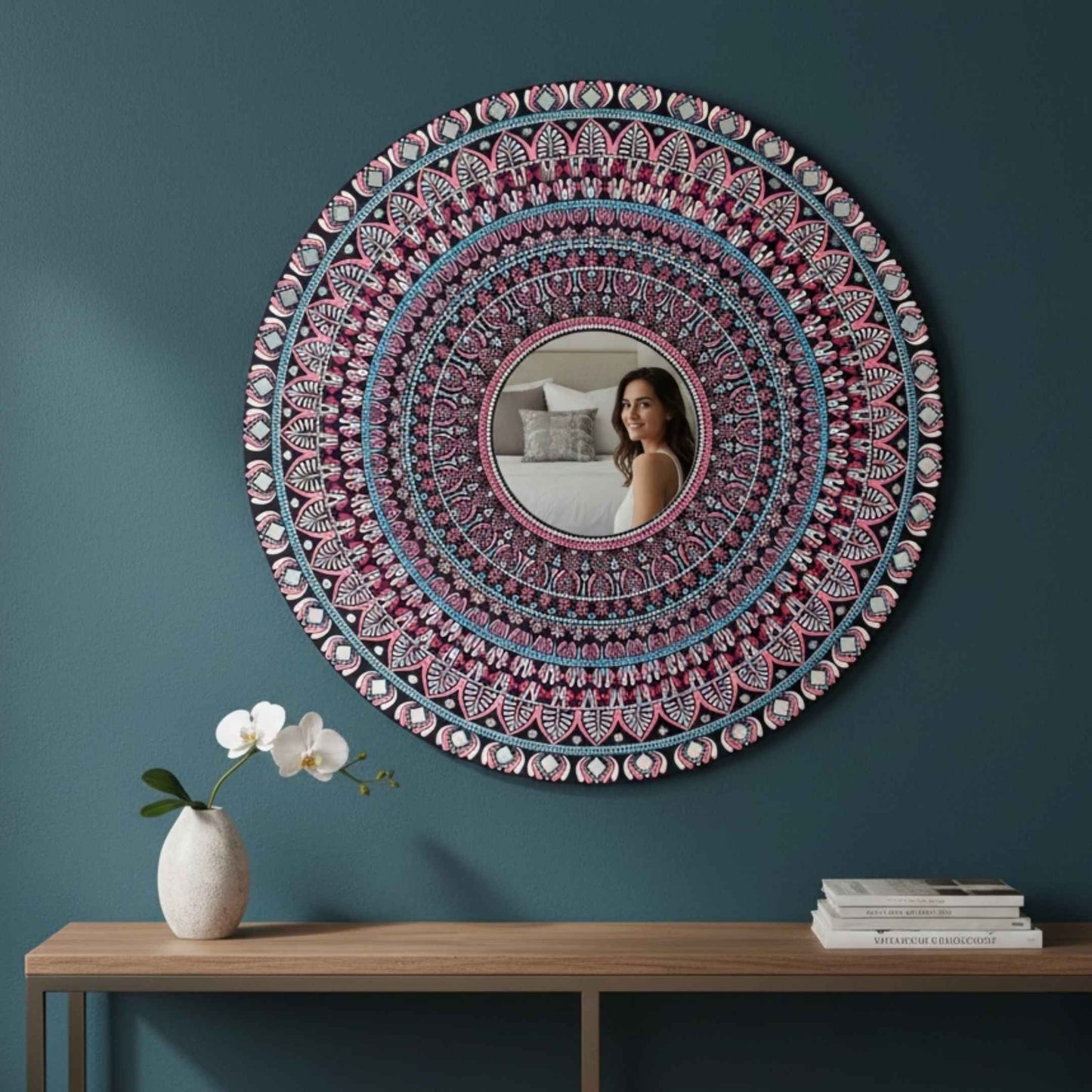 Mandala mirror wall art hung on teal wall above wooden console table decor