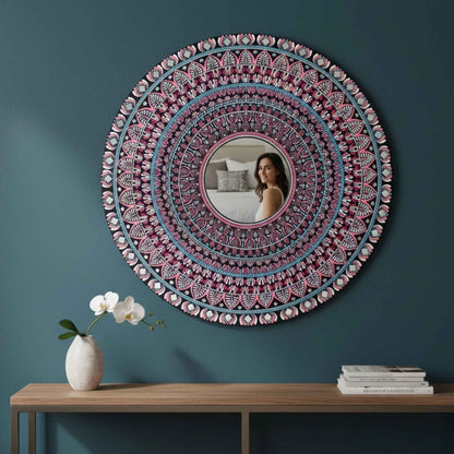 Mandala mirror wall art hung on teal wall above wooden console table decor
