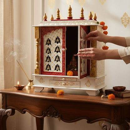 Woman performing a pooja in front of  Urli Utsav Mandir