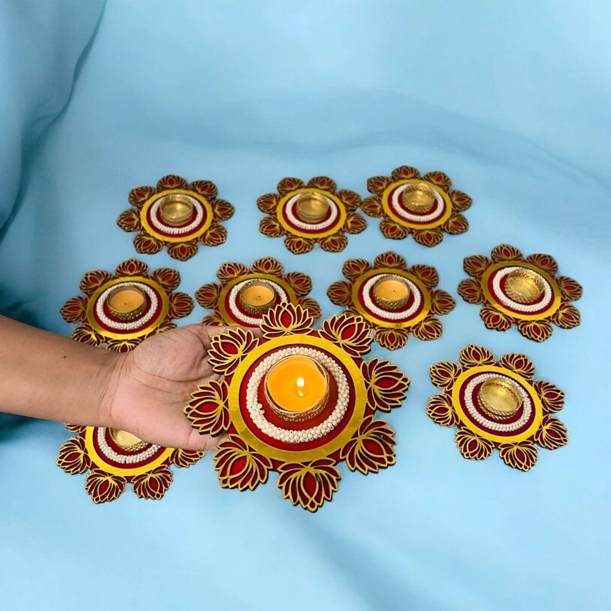 Decorative candles arranged in a circular pattern on a blue background