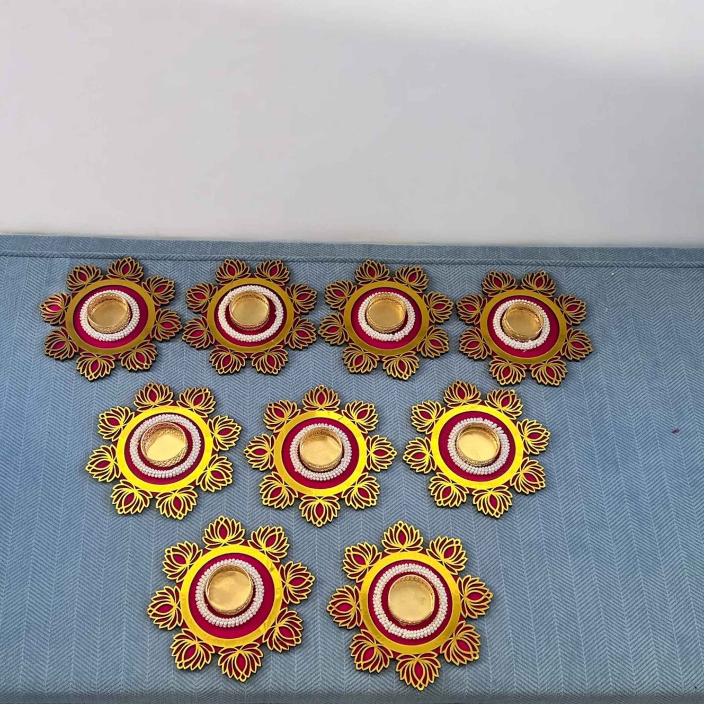 Decorative elements with yellow, red, and gold colors on a blue fabric background