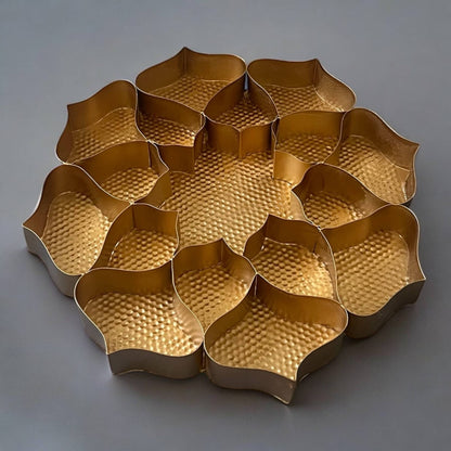 Gold metal tray with wavy edges on a gray background
