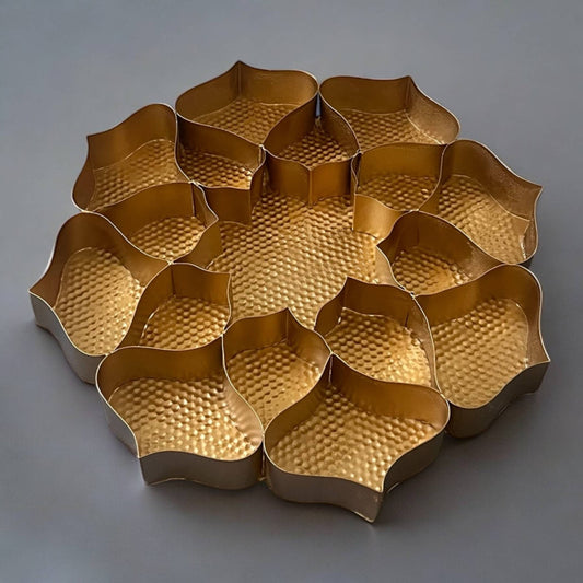 Gold metal tray with wavy edges on a gray background