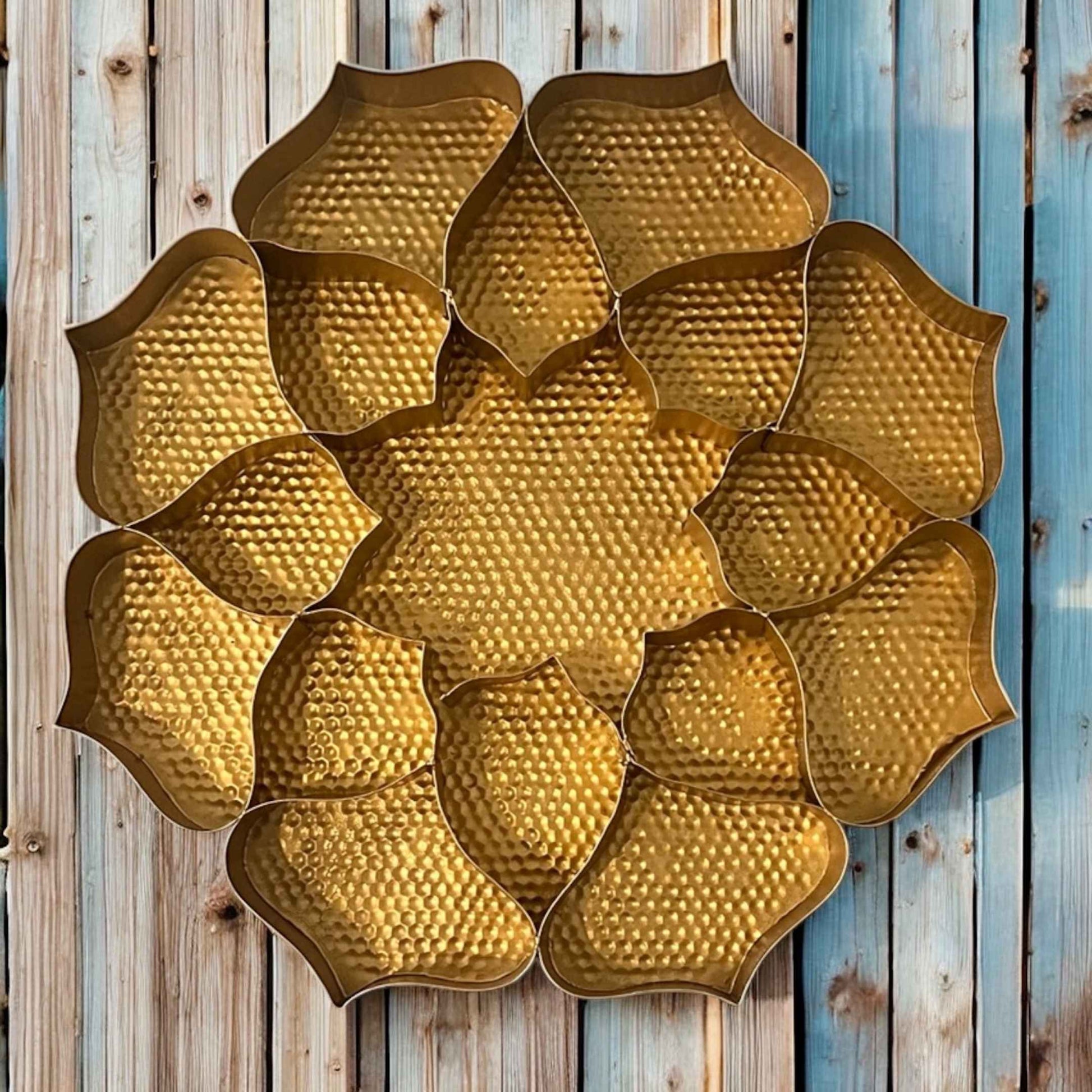 Decorative gold platter art piece on a wooden background