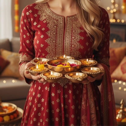 Traditional Indian Urli bowl filled with water and floating marigold flowers for Diwali decor.