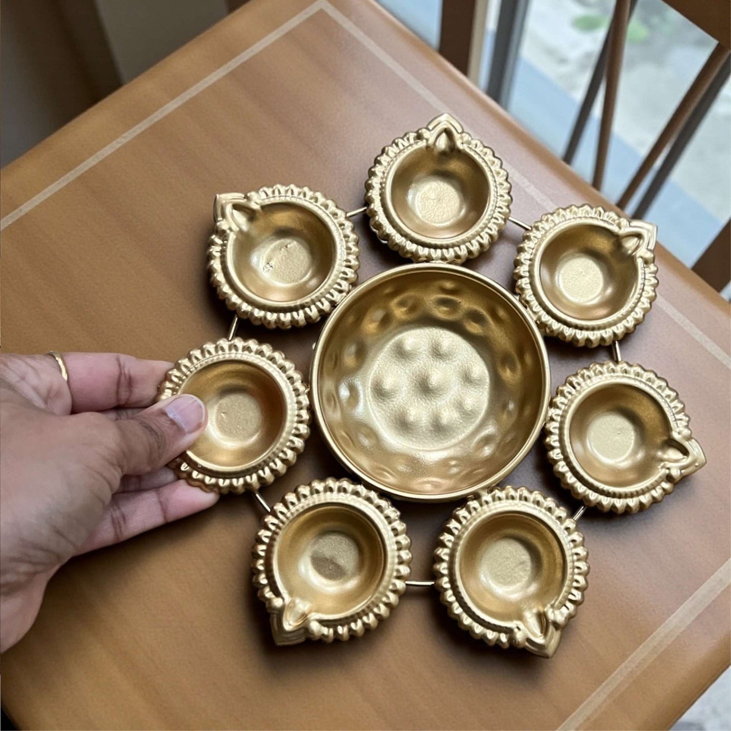 8-inch diameter mini gold Urli bowl perfect for tabletop or pooja room display.