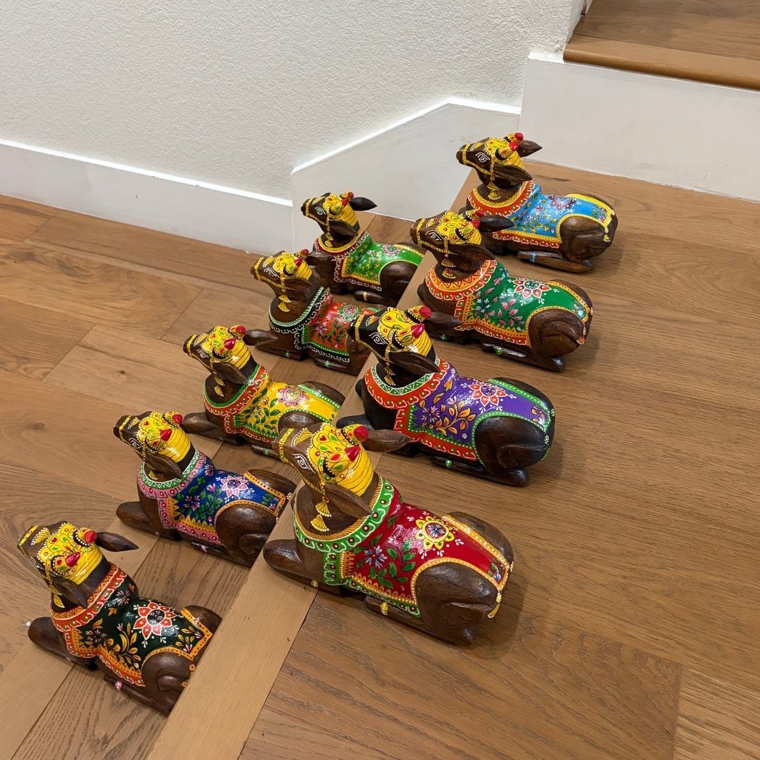 Colorful decorative dog figurines on a wooden floor