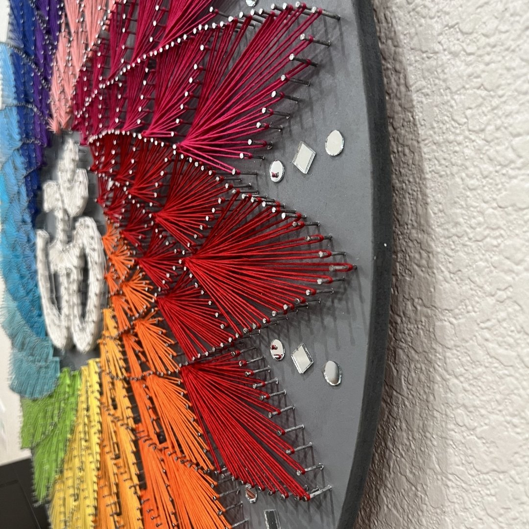 Delicate mirror work framing the Om string art design, adding a touch of brilliance to the handmade ethnic Indian wall decor.