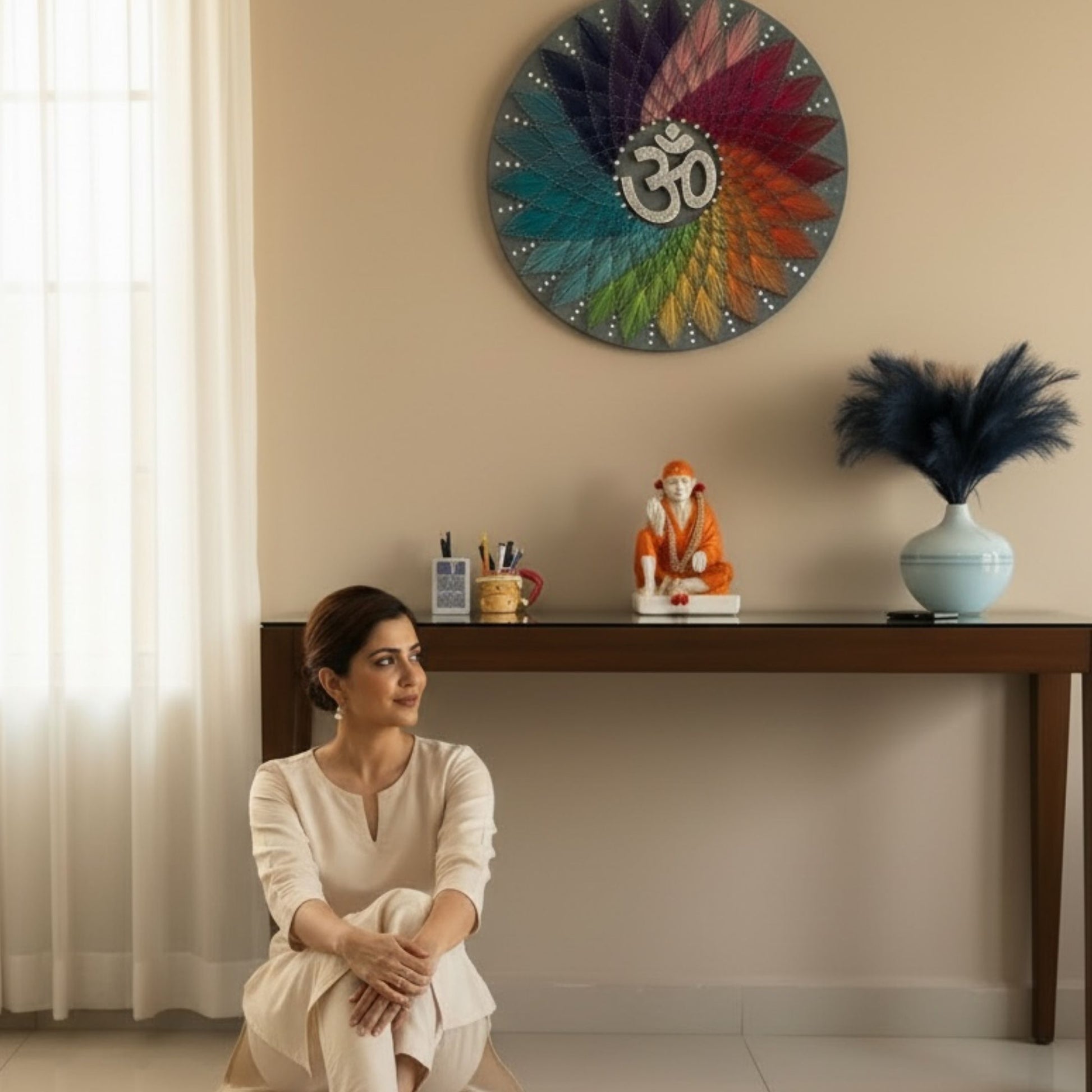 Woman sitting in a room with a colorful wall clock and decorative items.