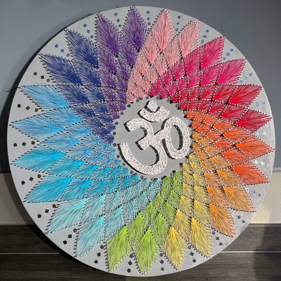 30-inch handmade Om AUM string art wall decor by Urli Utsav featuring vibrant colored threads and nails on a circular MDF board.