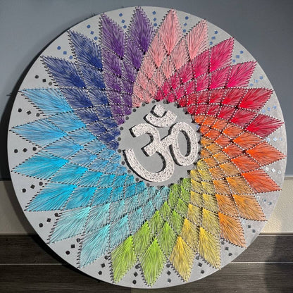 30-inch handmade Om AUM string art wall decor by Urli Utsav featuring vibrant colored threads and nails on a circular MDF board.