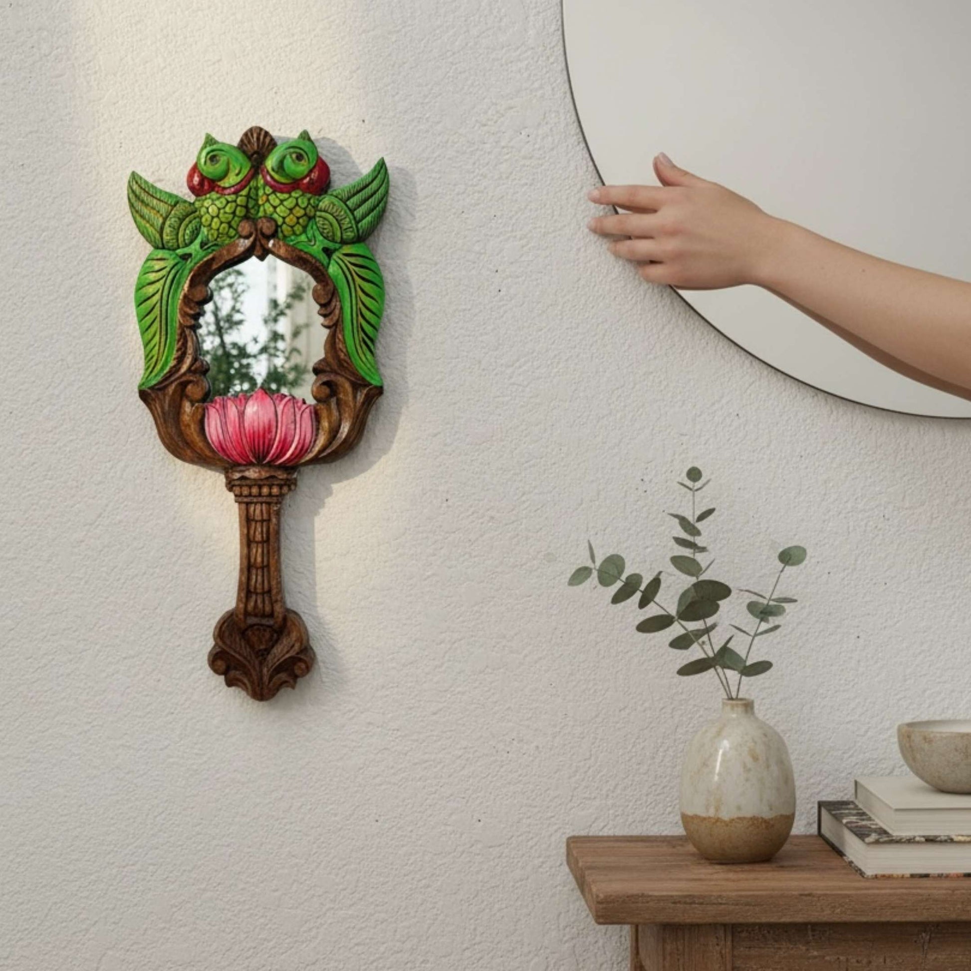 Hand-carved South Indian parrot mirror styled beside round wall mirror – boho Indian decor