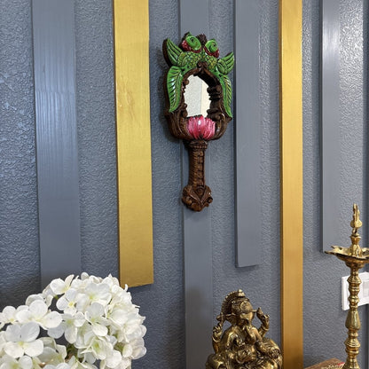 Pink lotus base detail of hand-carved Indian wooden mirror on gold accent wall – Diwali decor