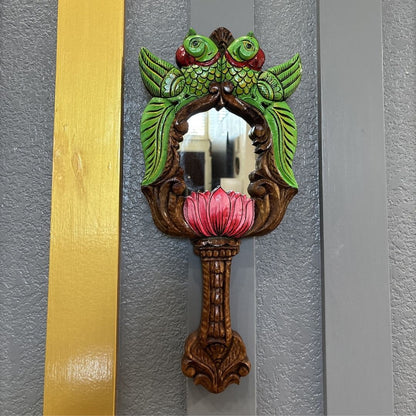 Hand-painted green parrot with red eyes and pink lotus – close-up of South Indian wood mirror