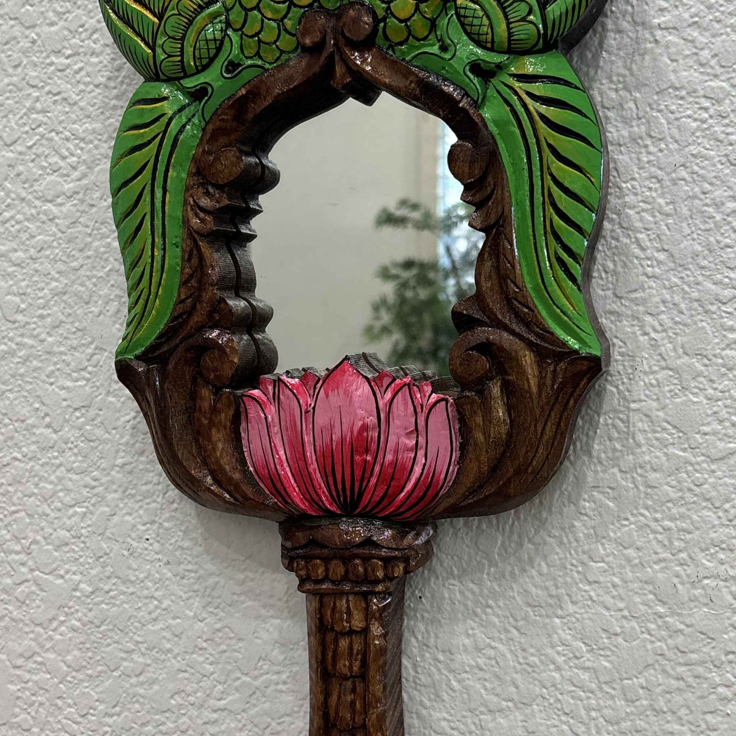 Pink lotus bloom and green leaf carving detail on hand-painted Indian wooden wall mirror