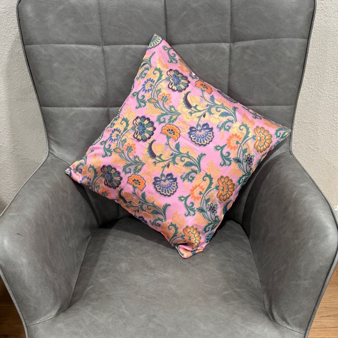 Close-up of a pink 16x16 inch silk blend Banarasi brocade cushion cover with golden floral motifs