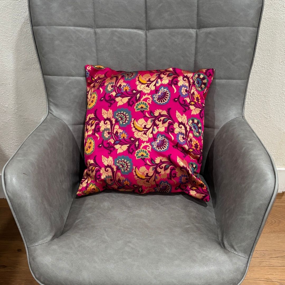 Close-up of a pink 16x16 inch silk blend Banarasi brocade cushion cover with golden floral motifs