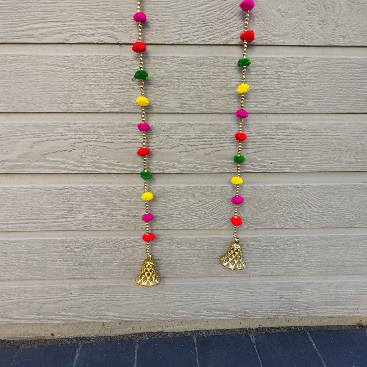 Handmade multicolor pompom garland with gold bells for Diwali home decor