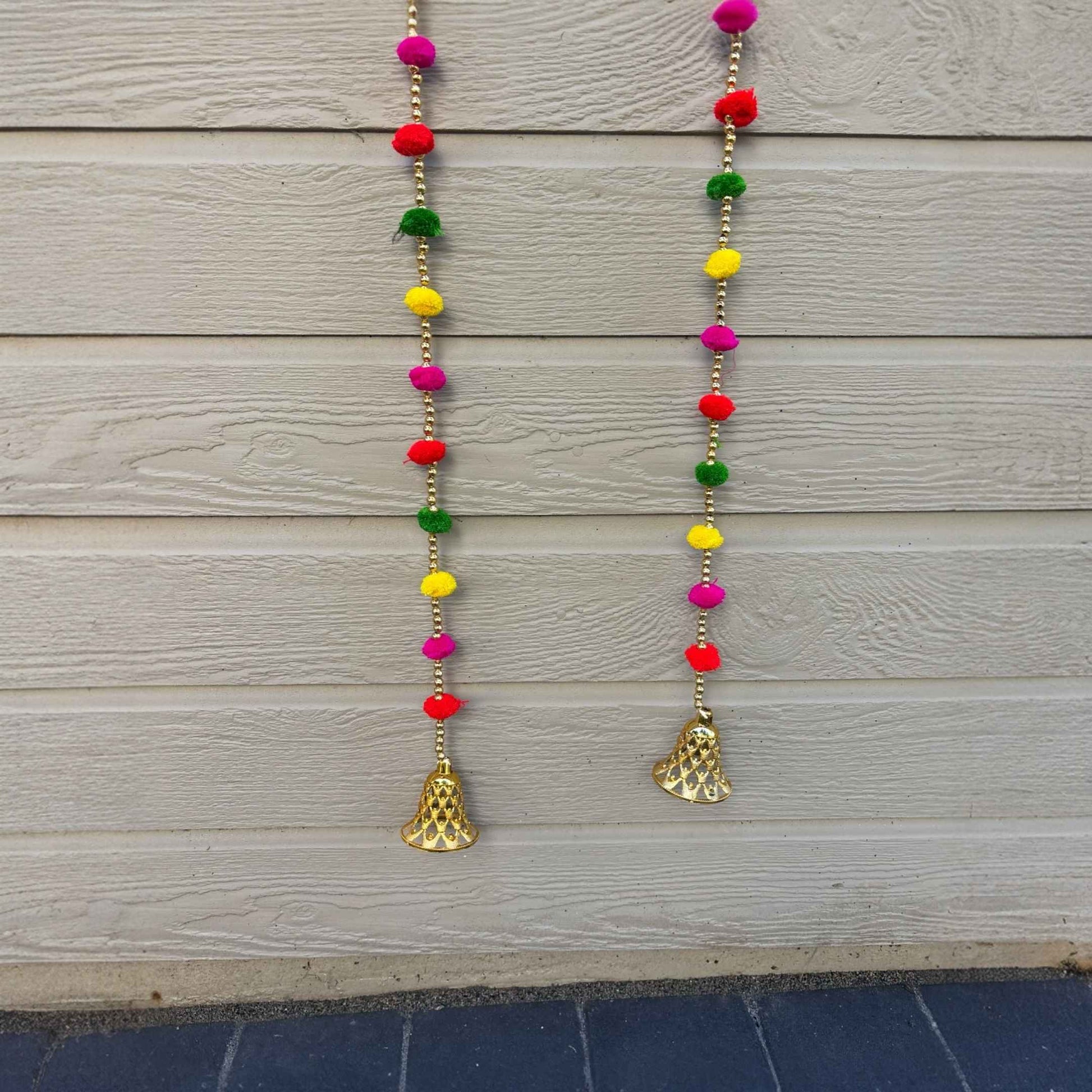Handmade multicolor pompom garland with gold bells for Diwali home decor