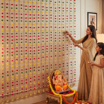 Family decorating with pompom garlands near Ganesha shrine for Indian festival