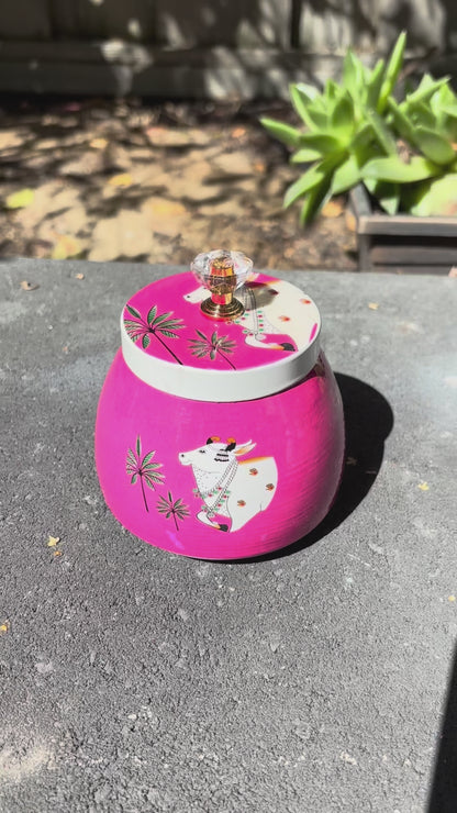 Video of Round Pichwai Cow Metal Jars showcasing all four design in pink, red, mint green and orange colors