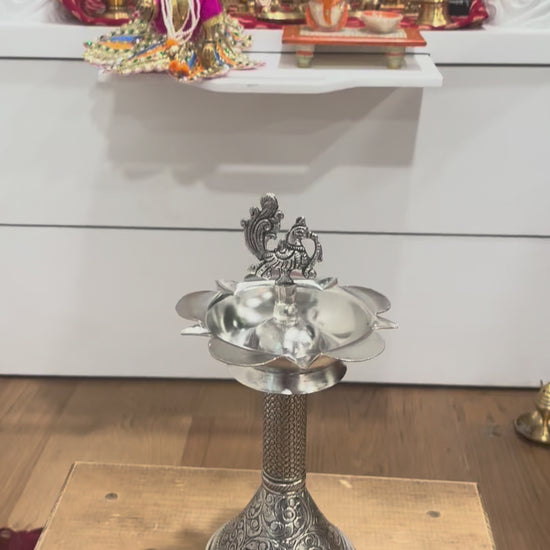 Video preview thumbnail showing 11-inch peacock samai oil lamps in antique silver finish