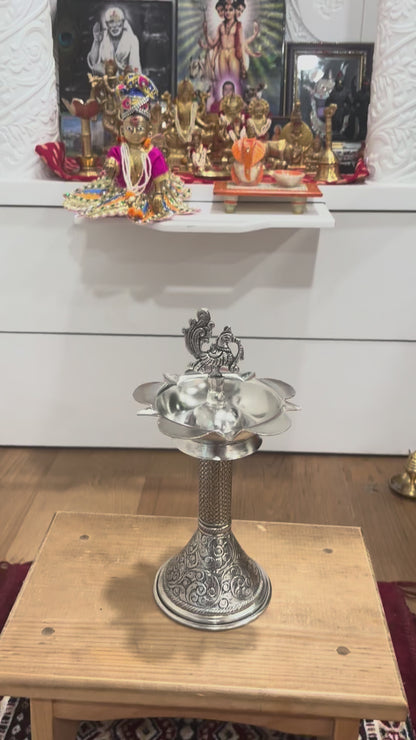 Video preview thumbnail showing 11-inch peacock samai oil lamps in antique silver finish