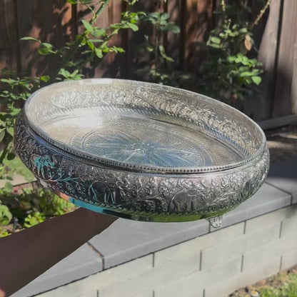 Video of the 13.5-inch antique silver elephant urli bowl: close-up of the raised elephant work, water poured in, then filled with red rose petals and floating tealights