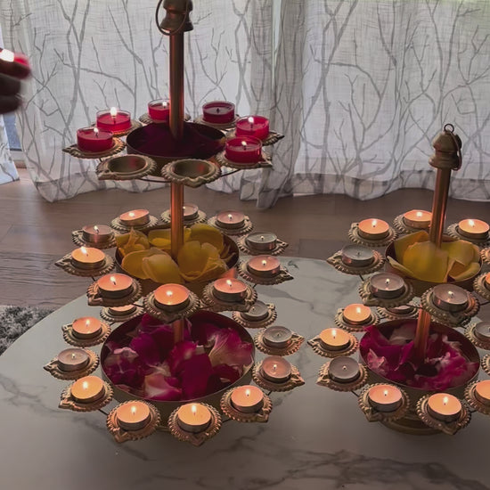 Video of of Urli Utsav three-tier Diya Urli Stand with 30 candle holders on a grey tabletop, perfect for Diwali decoration, Indian festival lighting, and home decor.