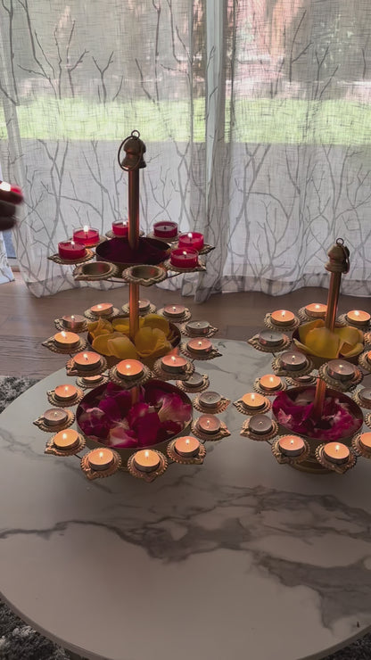 Video of of Urli Utsav three-tier Diya Urli Stand with 30 candle holders on a grey tabletop, perfect for Diwali decoration, Indian festival lighting, and home decor.