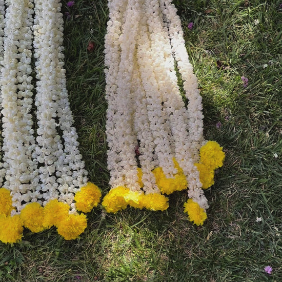 Video Of handcrafted artificial Mogra flowers with marigold bud on Urli Utsav's Indian garland, showcasing intricate design and craftsmanship