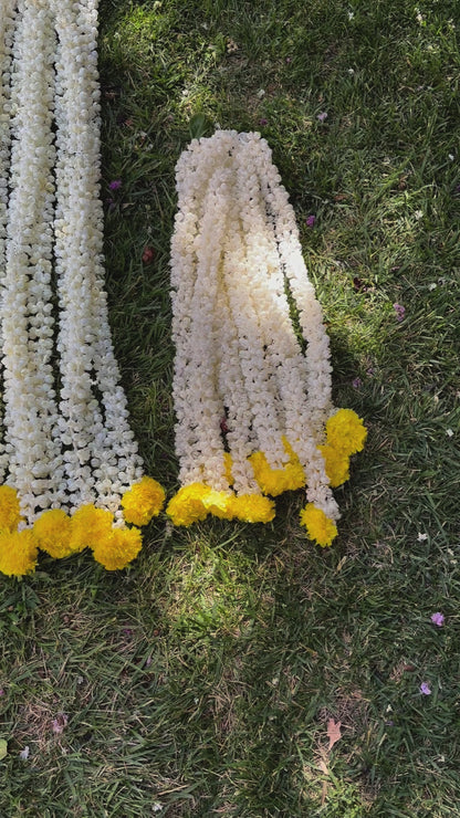 Video Of handcrafted artificial Mogra flowers with marigold bud on Urli Utsav's Indian garland, showcasing intricate design and craftsmanship