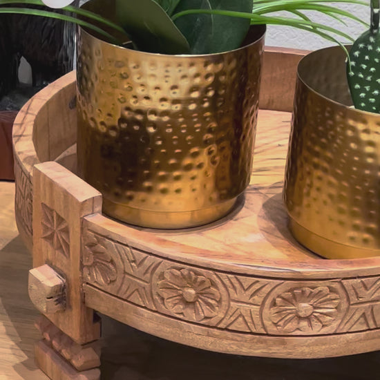 video showcasing indian decor setup featuring gold metallic planters paired with neutral tones and bohemian accents