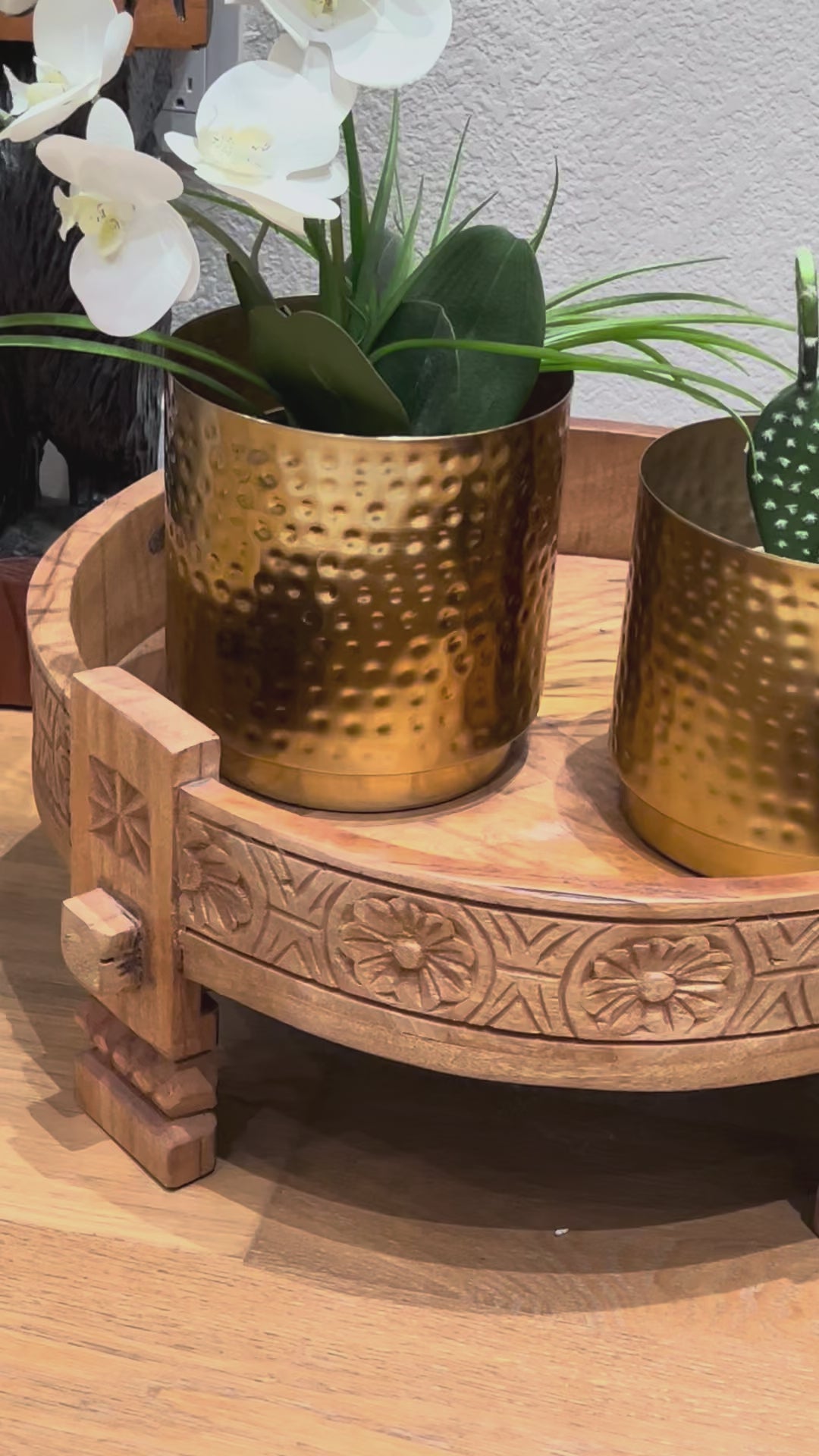 video showcasing indian decor setup featuring gold metallic planters paired with neutral tones and bohemian accents