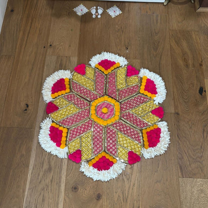 Colorful hexagon motif rangoli mat on a wooden floor
