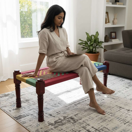 Handwoven charpai bench and stool styled in a modern boho living room