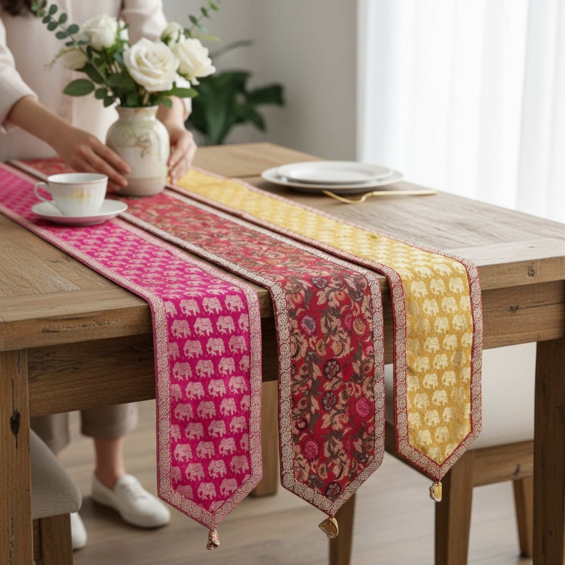 Colorful table runner with elephant pattern on a wooden table