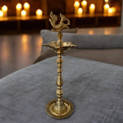 16 Inch tall Brass Mahabharat Diya illuminated, casting a warm glow; perfect brass lamp for enhancing Nilavilakku decor